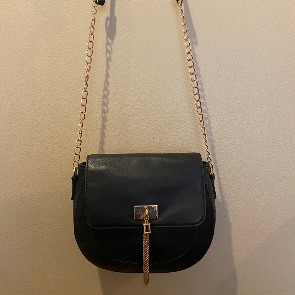 Black and gold “call it spring” crossbody bag